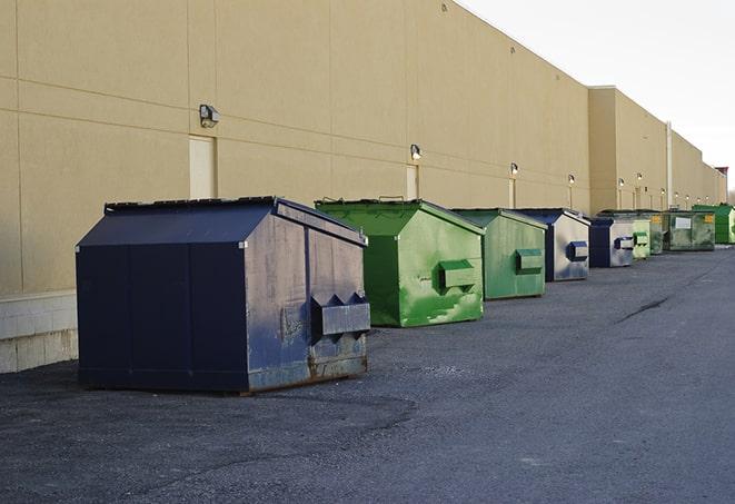 construction debris being dumped into dumpsters in Carrollton